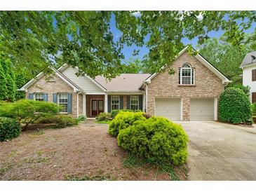 Charming brick home with a two-car garage, manicured landscaping, and inviting curb appeal at 3633 Gilpin Ct, Lawrenceville, GA 30044