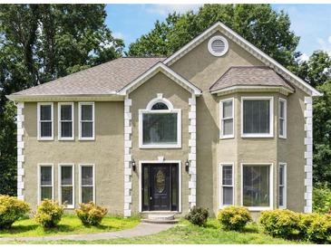 Charming two-story home with an arched window above the front door and detailed trim at 2108 Yorkshire Ct, Woodstock, GA 30189