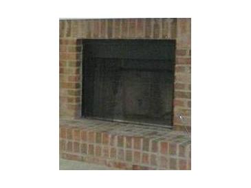 Close-up of a traditional brick fireplace with a black firebox at 687 Redland Dr # 687, Riverdale, GA 30238