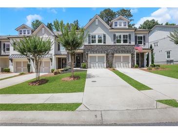 Charming townhomes feature stone accents, attached garages, and manicured front lawns at 146 Bellehaven Dr, Woodstock, GA 30188