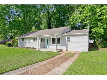 Charming single-story home featuring a well-maintained lawn, painted brick, and a cute front porch at 1735 Carter Cir, Atlanta, GA 30344