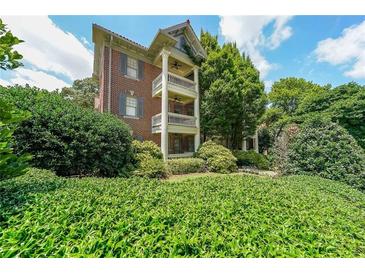 Three-story brick condo featuring private balconies, lush landscaping and classic architectural details at 2 Collier Nw Rd # 5, Atlanta, GA 30309