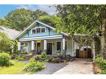 Charming two-story home with a landscaped front yard, welcoming porch, and private driveway with a covered parking area at 570 Park Se Ave, Atlanta, GA 30312