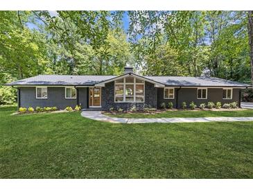 Charming single-story home with painted brick, new roof, and professionally landscaped front yard at 3008 Ridgeside Ct, Atlanta, GA 30341