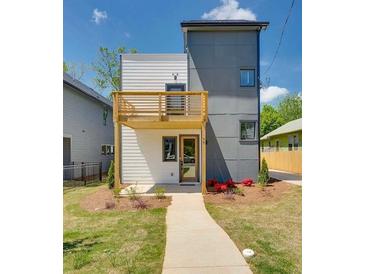 Contemporary two-story home with a balcony, neutral color scheme, and a well-manicured lawn at 76 Mayson Avenue Northeast Ne, Atlanta, GA 30307