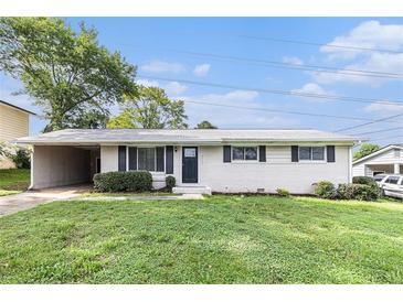Charming one-story home featuring a brick facade, carport, and well-maintained front yard at 3787 Stephanie Sw Dr, Atlanta, GA 30331
