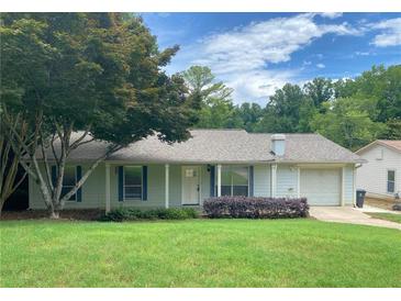 Charming single-story home with a well-manicured lawn and inviting front porch with light blue shutters at 1150 Terramont Dr, Roswell, GA 30076