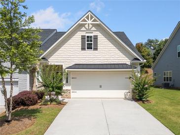 Charming home with a well-manicured lawn and a two-car garage and a lovely front yard with attractive plantings at 4571 Grenadine Cir, Acworth, GA 30101