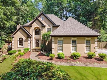 Charming home with manicured front yard and inviting entrance, surrounded by lush greenery at 2505 Ridgehurst Dr, Buford, GA 30518
