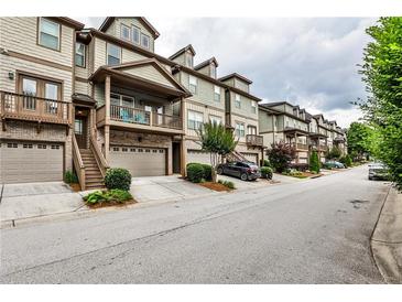 Charming townhome complex featuring neutral exteriors, private garages, and inviting front porches and decks at 680 Emeril Dr, Avondale Estates, GA 30002