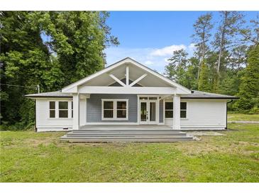 Charming home featuring a welcoming front porch, gray accents, and a well-manicured lawn at 2552 Scenic S Hwy, Snellville, GA 30078