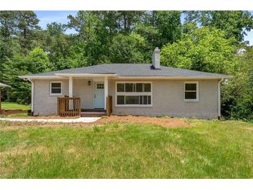 Charming one-story home with a brick facade, manicured lawn, and inviting front porch at 1364 Willis Mill Sw Rd, Atlanta, GA 30311