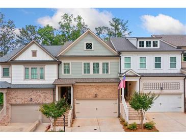 Charming townhome with brick accents, a one-car garage, and well-maintained landscaping at 233 Retreat Ln, Canton, GA 30114