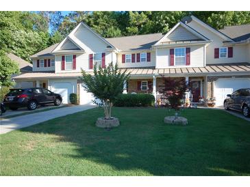 Charming townhome with a well-manicured lawn, attached garage, and lovely curb appeal at 70 Darbys Crossing Ct, Hiram, GA 30141
