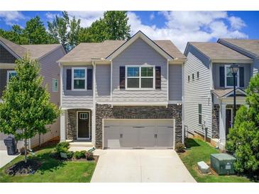 Charming two-story home with stone accents, attached two-car garage and nicely landscaped front yard at 550 Constellation Overlook Sw, Atlanta, GA 30331