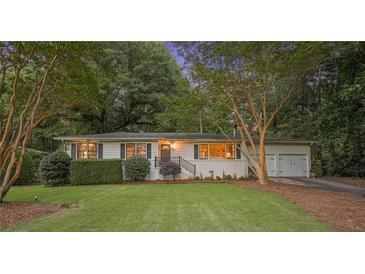 Charming one-story home with a well-manicured front yard and a quaint walkway leading to the front door at 3357 Pretty Branch Se Dr, Smyrna, GA 30080