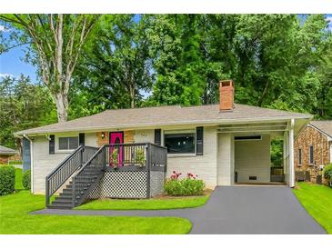 Charming single story home featuring a pink front door, a carport, and mature trees at 240 W Lake Nw Dr, Atlanta, GA 30314