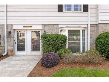 Charming front entrance with double doors, stone accents, and a bay window bringing in natural light at 136 Peachtree Memorial Nw Dr # Ct-6, Atlanta, GA 30309