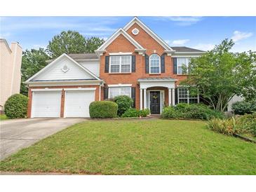 Charming two-story brick home featuring a well-manicured lawn and a two-car garage at 3616 Myrtlewood Nw Ct, Kennesaw, GA 30144