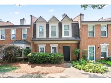 Charming brick townhome with well-maintained landscaping and inviting entrance at 4167 Oakwood Way, Duluth, GA 30096