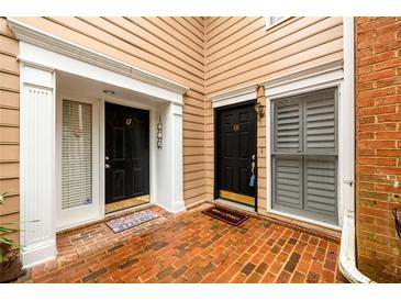 Charming townhome entrances featuring brick flooring and stylish black doors with white trim at 7500 Roswell Rd # 18, Sandy Springs, GA 30350