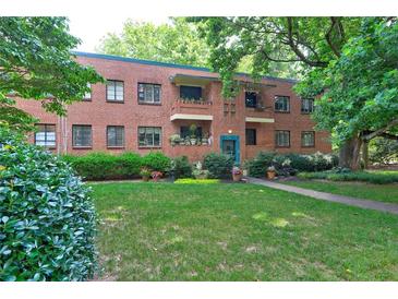 Charming brick building with landscaped front yard and a variety of plants and greenery at 1400 Chalmette Ne Dr # 2, Atlanta, GA 30306