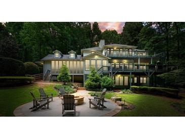 Expansive backyard with a patio, chairs, and firepit perfect for outdoor enjoyment and relaxation at 627 Apache Trl, Woodstock, GA 30189