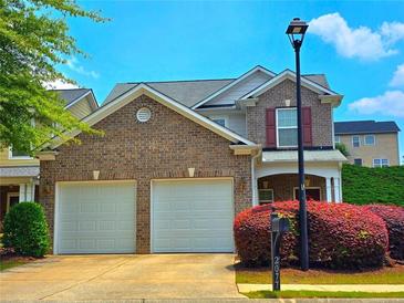 Charming two-story home with a brick facade and two-car garage, complemented by a well-manicured front yard at 2077 Appaloosa Way Way, Conyers, GA 30012