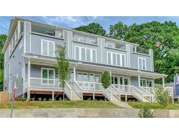 Modern townhome featuring a gray exterior, multiple decks, and manicured landscaping at 458 Connally Se St, Atlanta, GA 30312