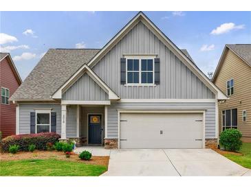 Charming home featuring neutral siding, a two-car garage, and a well-maintained front yard at 3018 Patriot Square, Marietta, GA 30064
