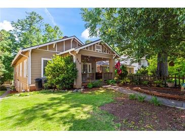 Charming single-story home with a well-maintained lawn and inviting front porch at 210 Evans Dr, Decatur, GA 30030