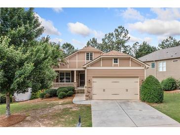 Charming two-story home featuring a covered porch and a two-car garage with a well-manicured front yard at 238 Balsam Dr, Canton, GA 30114