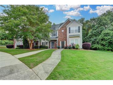 Charming two-story home with well-maintained lawn, mature trees, and a welcoming walkway at 2803 Snapfinger Manor Mnr, Decatur, GA 30035
