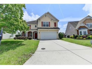Two-story home with red shutters, manicured lawn, and a long driveway at 7196 Toccoa Circle, Union City, GA 30291