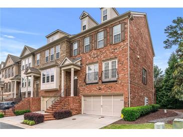 Beautiful brick townhome with attached garage, charming facade, and manicured landscaping at 2428 Hadlow Ln # 25, Atlanta, GA 30339