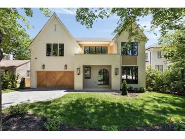 Stunning two-story home featuring a beautiful brick facade, wooden garage doors, and well-maintained landscaping at 2609 Dogwood Terrace Ne, Atlanta, GA 30319
