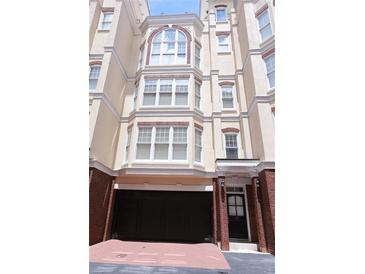Charming townhouse with brick accents, large windows, and an attached garage at 3541 Roswell Ne Rd # 20, Atlanta, GA 30305