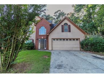 Charming two-story home with a brick accent and a well-maintained front yard at 1464 Claredon Dr, Lawrenceville, GA 30043