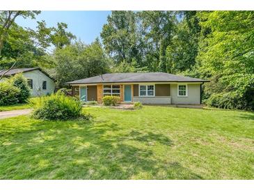 Charming single story home with a well-manicured lawn and mature trees providing shade at 2935 Catalina Dr, Decatur, GA 30032