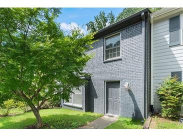 Charming brick home with a well-maintained lawn and mature trees in a desirable neighborhood at 1731 Twin Brooks Se Dr, Marietta, GA 30067