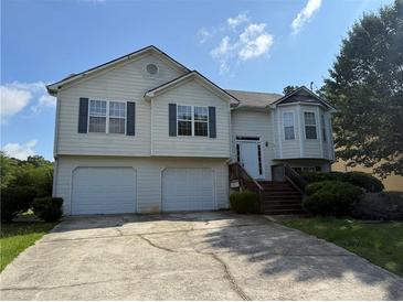 Split level home with two-car garage, dormer window, and classic design at 380 Paper Mill Rd, Lawrenceville, GA 30046