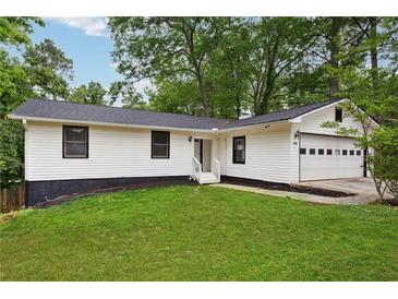 Charming single story home with an attached garage, manicured lawn and fresh landscaping at 383 Oakridge Dr, Cartersville, GA 30121