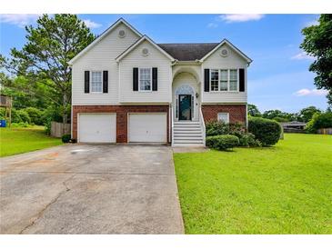 Charming two-story home with a brick and siding exterior and a well-maintained front yard at 4905 Martin Farms Dr, Powder Springs, GA 30127