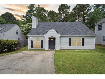 Charming single-story home with a well-manicured lawn, black shutters, and a classic gray front door at 3530 Boulder Cir, Ellenwood, GA 30294