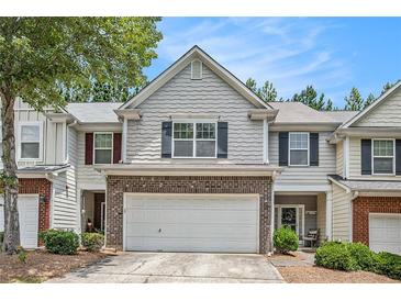 Charming townhome featuring gray siding, brick accents, and a two-car garage in a well-maintained community at 461 Mountain View Ln, Woodstock, GA 30188