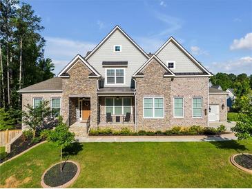Charming two-story home featuring a landscaped front yard and a mix of stone and brick exterior at , Kennesaw, GA 30152