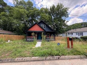Charming single-Gathering home with a well-maintained front yard and mature trees at 1149 Tucker Sw Pl, Atlanta, GA 30310