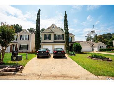 Charming two-story home with a well-manicured lawn, driveway, and beautiful landscaping, showcasing curb appeal at 1312 Glenover Way, Marietta, GA 30062
