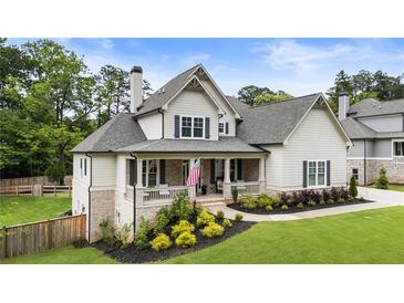 Charming two-story home with a welcoming front porch and beautifully landscaped yard at 4395 Capstone Court, Roswell, GA 30075
