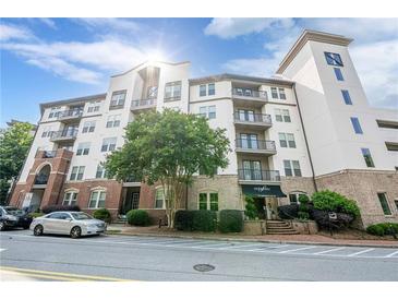 A striking exterior view of the Serrano condominium building, showcasing its architectural charm and inviting entrance at 901 Abernathy Ne Rd # 3020, Atlanta, GA 30328